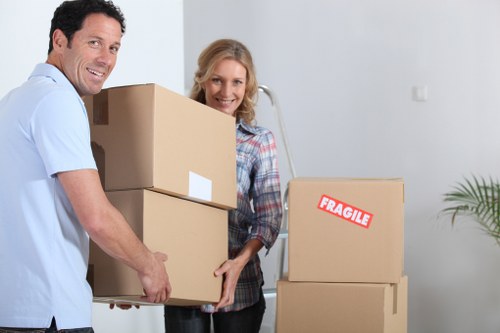 Professional movers handling office equipment